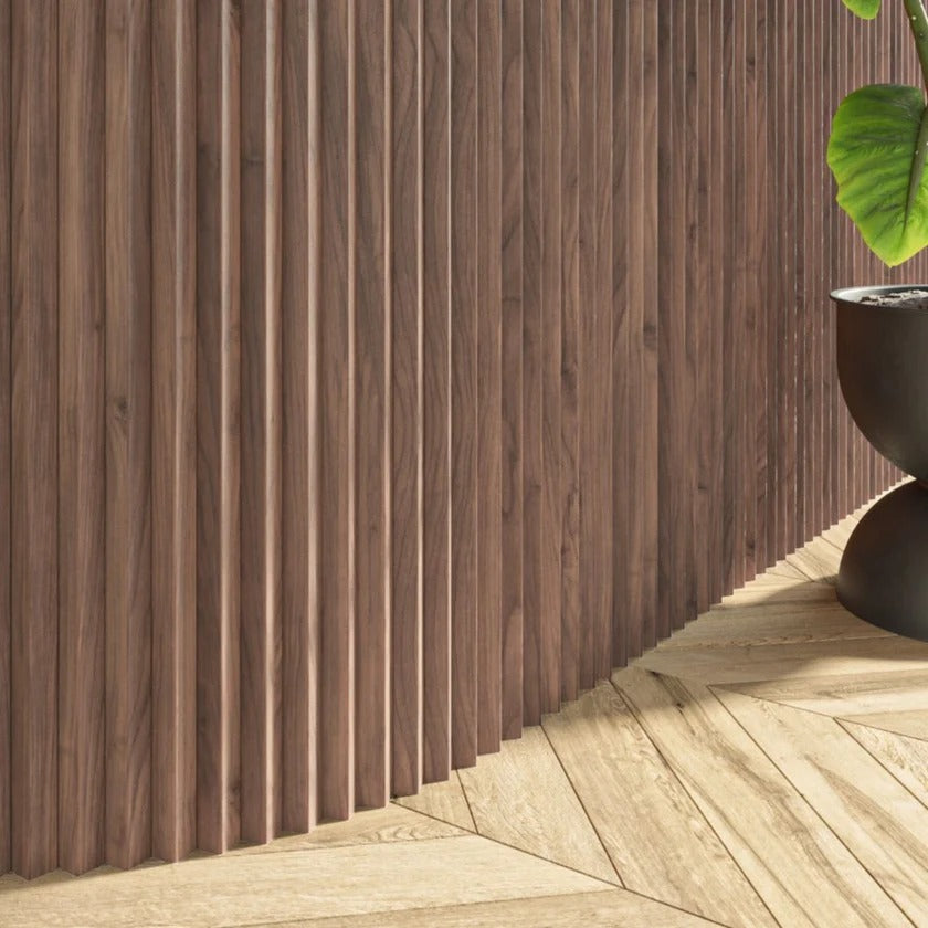 Wooden wall paneling with a plant on a wooden floor